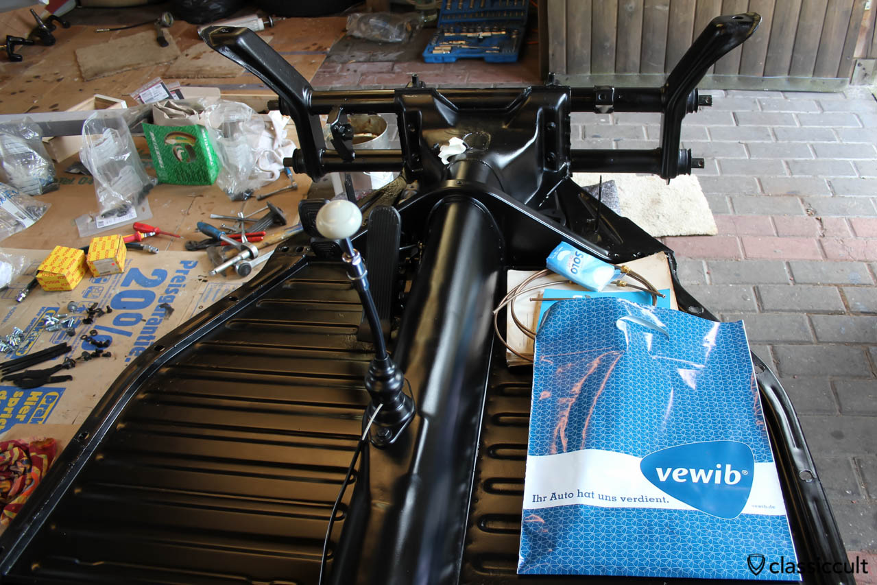 VW Beetle restoration assembling the floor pan with restored, nos and new parts.