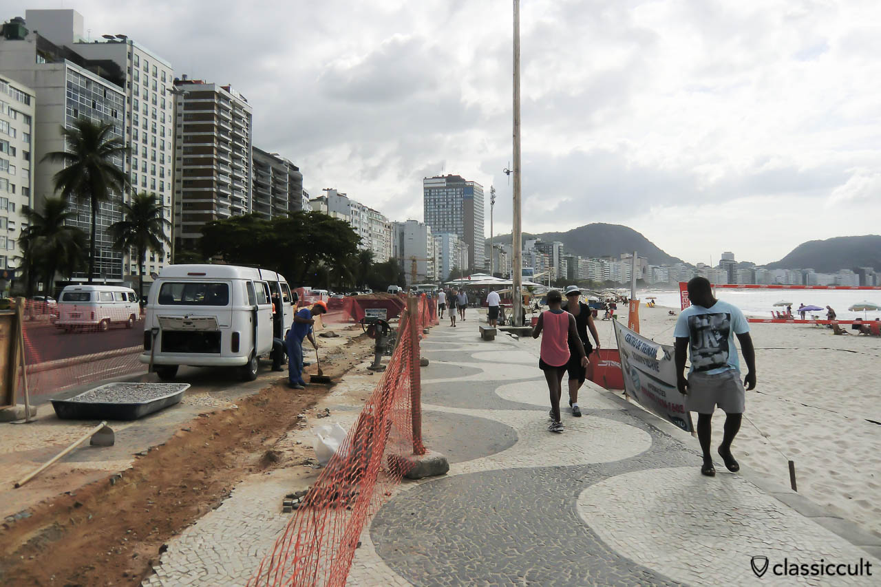 Brazilian VW Kombi Bus at Copacabana Promenade, Rio, Brazil, May 22, 2013. The construction workers are repairing the nice Copacabana beach wave pattern promenade.