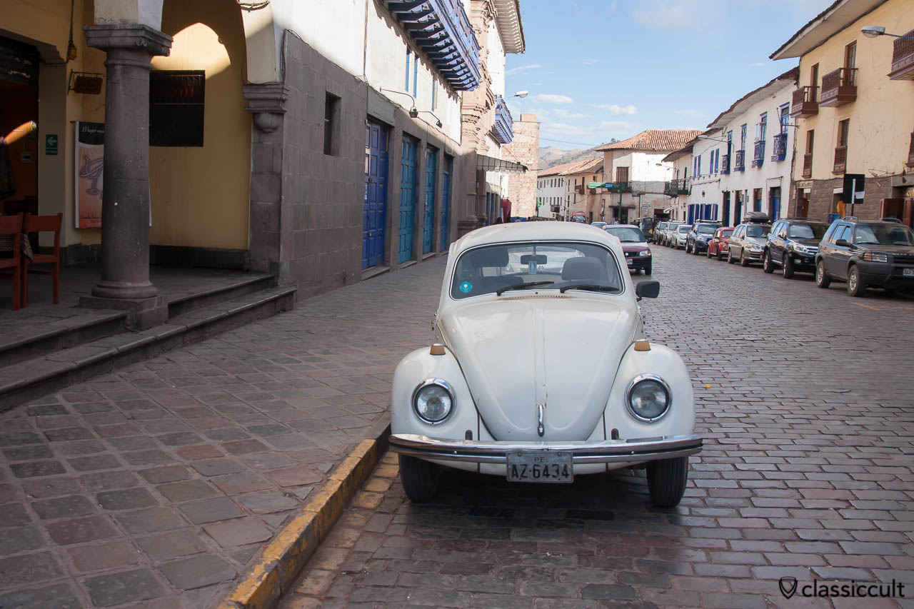Classic VW Beetles in the city center of Cuzco, Peru, May 11, 2013. The second beetle is parking on the right hand side of the road.