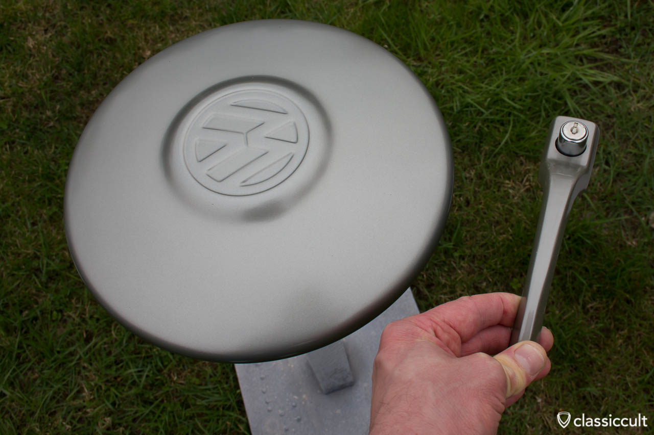 VW 1200 A Bug Hubcap painted L328 steel grey, compared to a nos 1967 Volkswagen Standard Beetle door handle