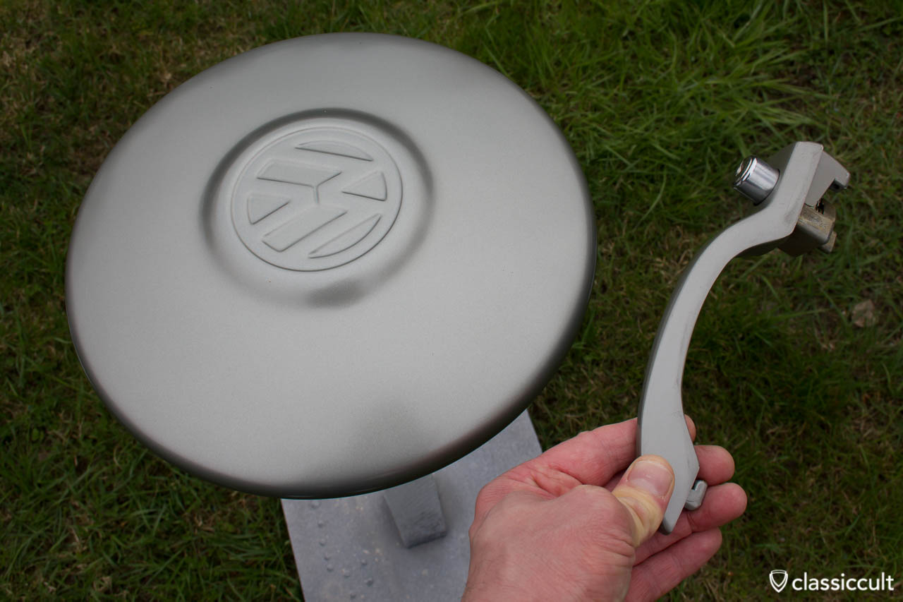 VW 1200A 1965 1966 Hubcap painted L328 steel grey, compared to a nos Standard Beetle door handle