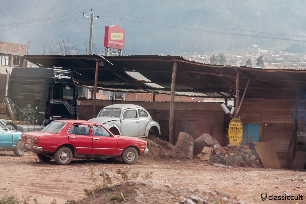 VW Bug without wheels seen from Cusco to Puno train, Peru, May 15, 2013